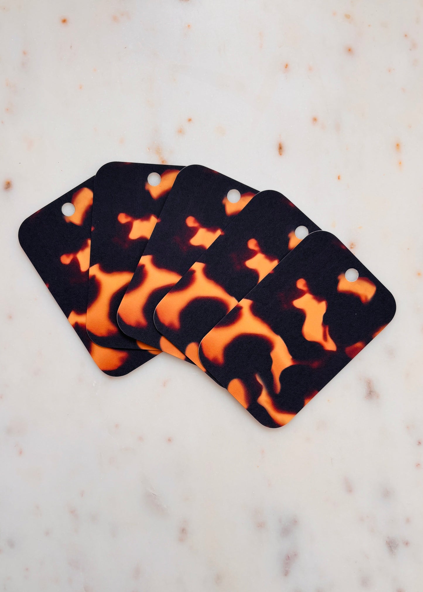 Five Tortoiseshell patterned Gift Tags fanned out one on top of the other on a marble background