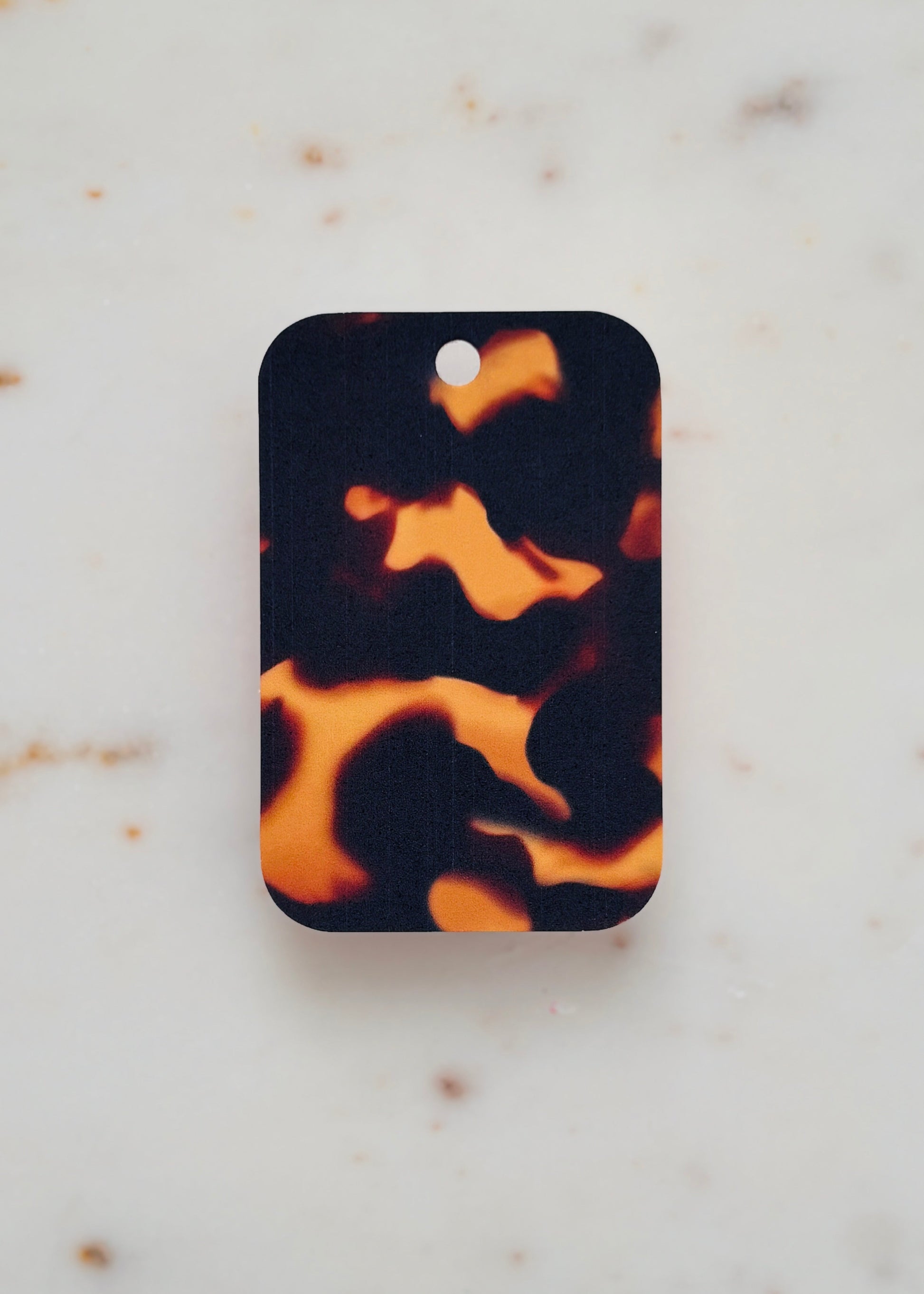 Tortoiseshell patterned gift tag on a marble background