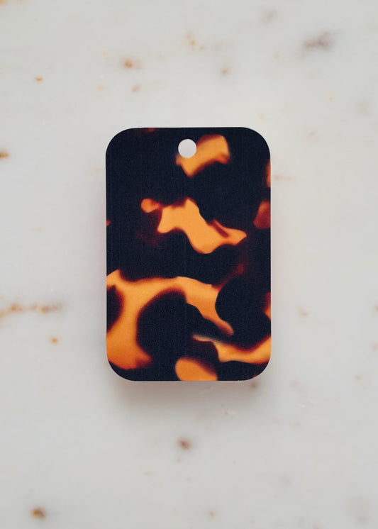 Tortoiseshell patterned gift tag on a marble background